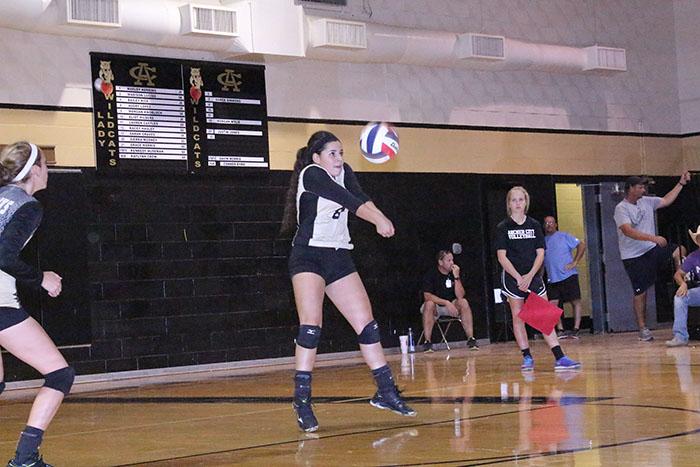 Junior Audry Lopez bumps the volleyball to her teammate in the Ladycats win over Holliday. 