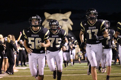 Players Keaton Coleman, Dalton Drennan and Jarrod Richey race onto the field after half-time.