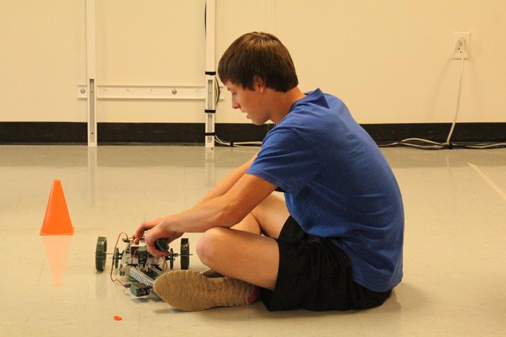 Junior Jeremiah Cooke works on his robot as the class experiments with their inventions.