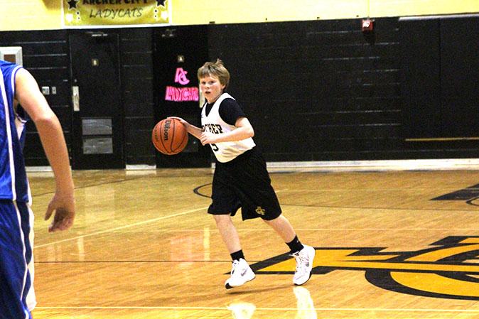Running down the court, eighth grader Kade Dagley looks for another teammate to pass to.