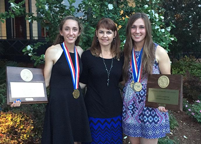 Junior Maeley Herring and senior Morgan Knobloch stand with UIL Coach Carol Cox. Together, the girls won the first place journalism team award.