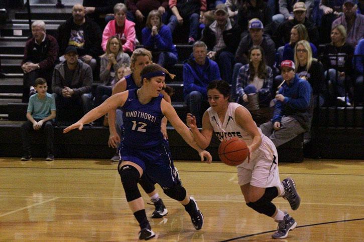 Senior Audry Lopez dribbles down the court to set up the Ladycat offense against the Trojanettes.