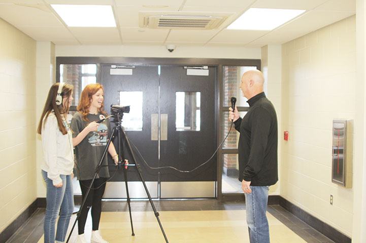 Juniors Abby Aulds and Sierra Mooney interview staff for video that will be presented at the open house event.