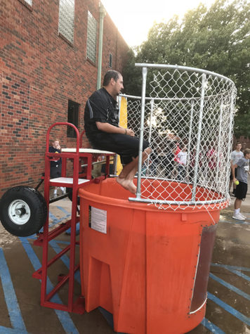 Coach Andrew Morris sits in the dunk tank awaiting the dunk of doom.
