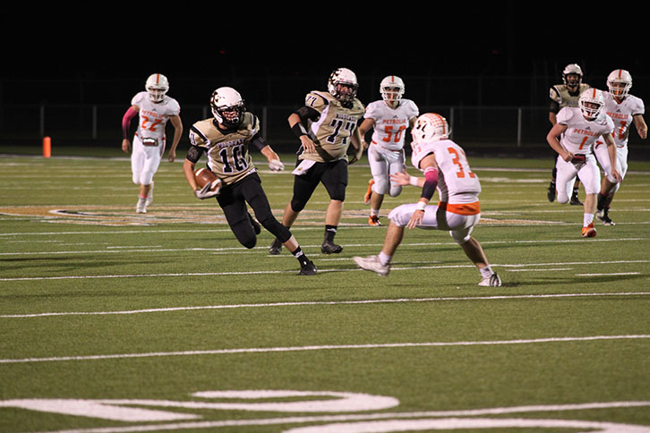 Freshman Jed Castles avoids a tackle in the game against Petrolia 