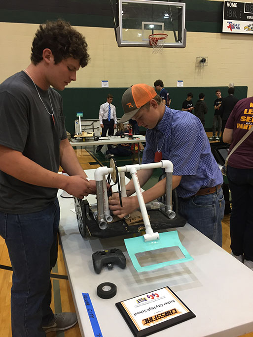 Junior Clay McCasland and sophomore Blake Dunkel make some final adjustments to their teams robot before the UIL robotics competition. The team place sixth at the competition and will be advancing to state in December 