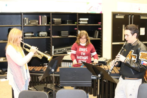 Juniors Emily Strenski and Robin Samtlebe, and senior Emily Richardson practice their music. They competed for a spot in the all-district and all-region bands.