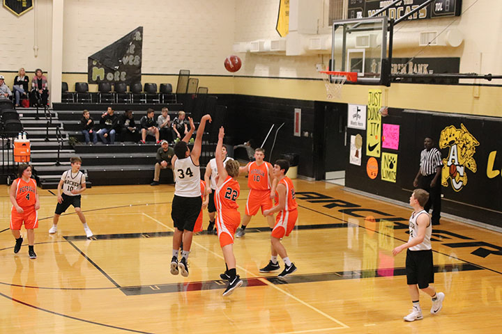 Eighth grader Chris Allen shooting the basketball.