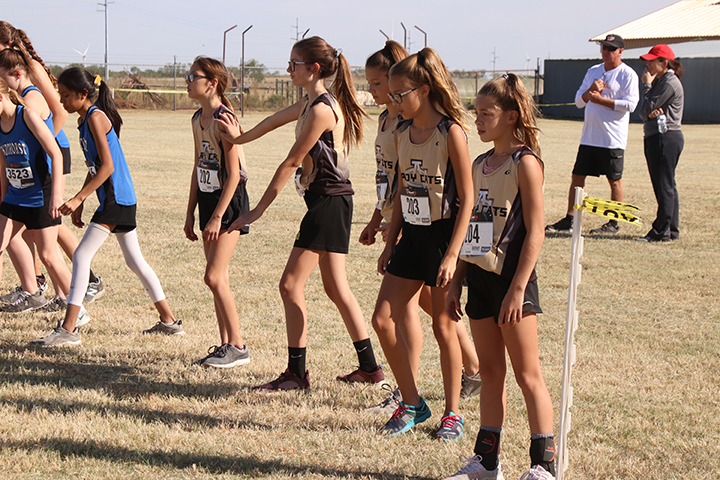 The junior girls cross country team waits for the starting gun at the district meet on Oct. 16. The team placed first. 