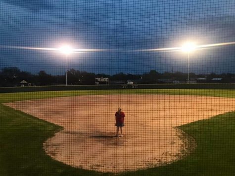 Coach Mallory Mooney looks out over the empty Ladycat softball field during the UIL suspension.