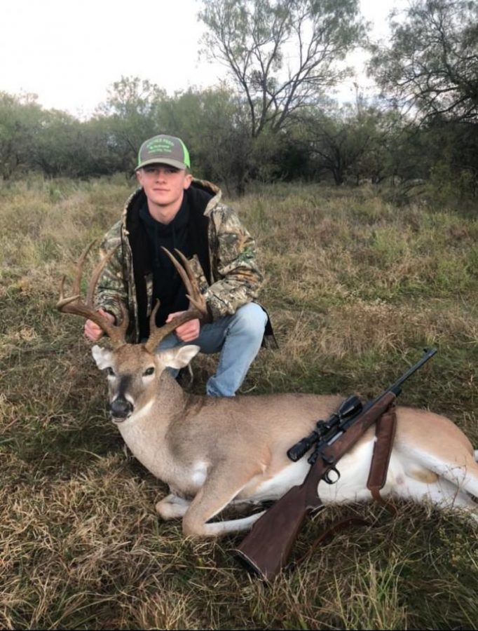 Junior Gunner Smith poses with his kill on the first day of rifle season last November 