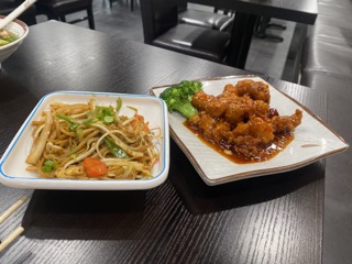 General Tsos Chicken with a side of noodles. Typically dishes are served with rice, but for an up-charge you can pick between the two.