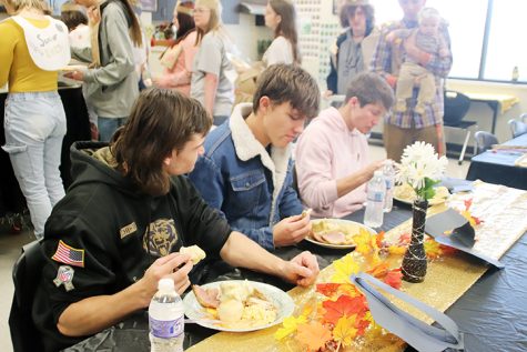 Seniors Dominic Thomas, Eli Anderson and McKinnen Beaver converse while eating their food.