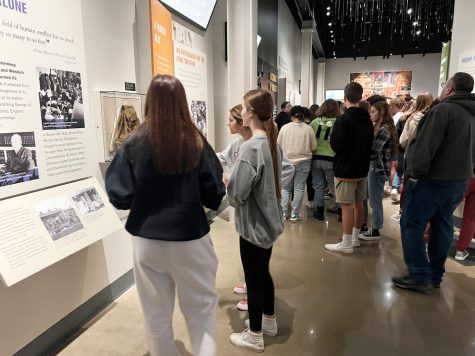 Juniors Kaydyn Ritchie, Kambri David and Katelyn Casillas observe a backpack taken from a concentration camp.