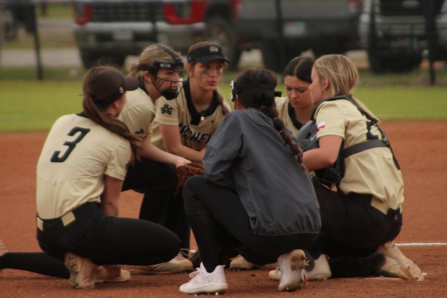 The infield players take a knee during an injury timeout in the game against Windthorst. The Ladycats will host Petrolia at 1 p.m. Friday.