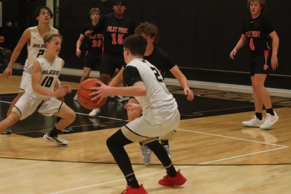Freshman Gage McCord dribbles the ball down the court to score