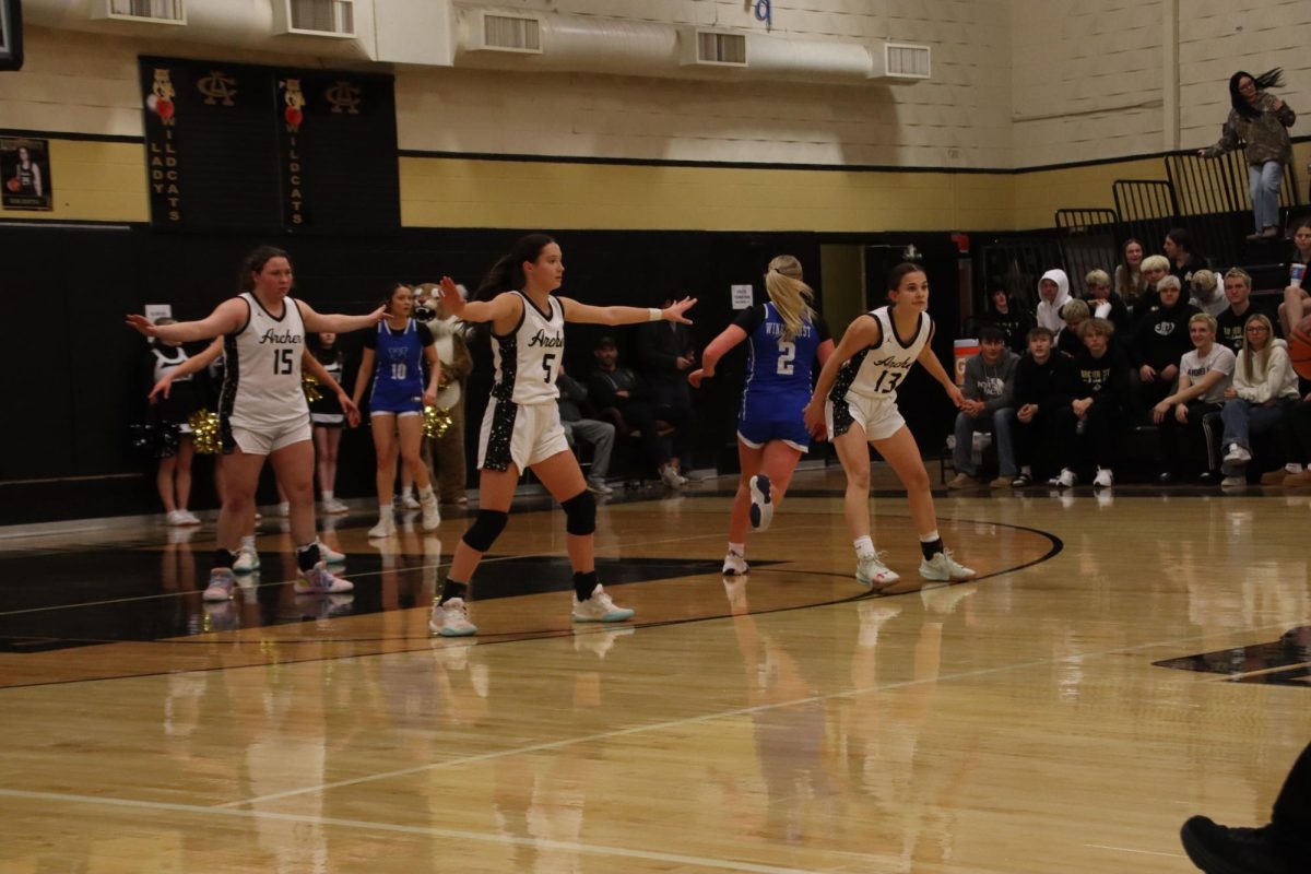 Seniors Adelyn Harvey, Alyssa Shroeder and freshman Millie Mayo play defense against Windthorst. 