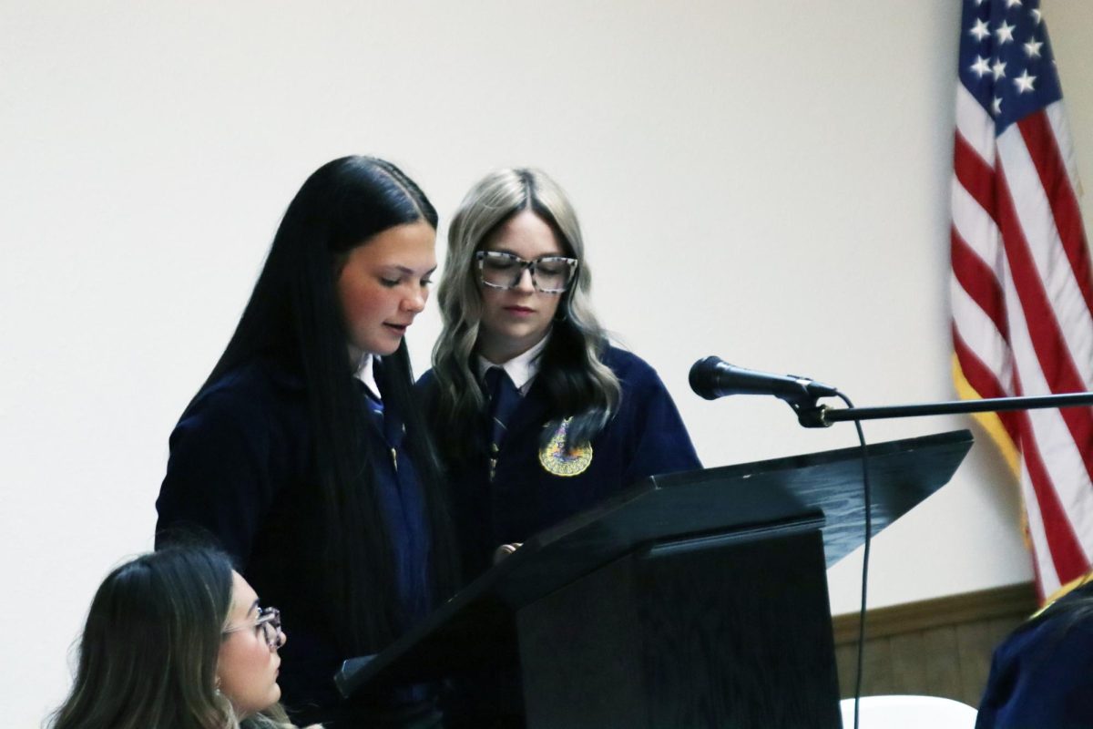 Senior Victoria Foster, junior Brilee Canada and senior Zoey Bates speak at the FFA banquet on May 5. 